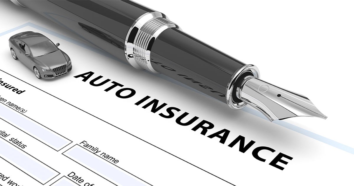 Fountain pen and model car on an auto insurance document.