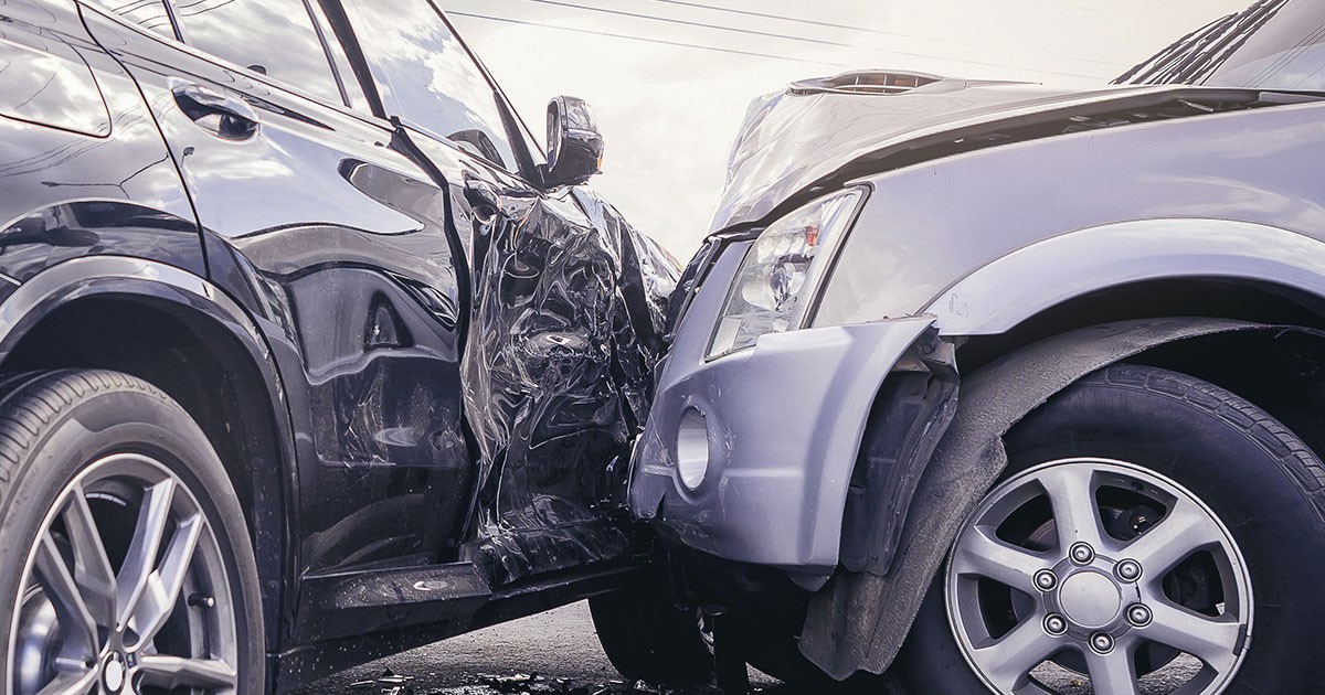 Two cars involved in a side-impact collision, with significant damage visible.